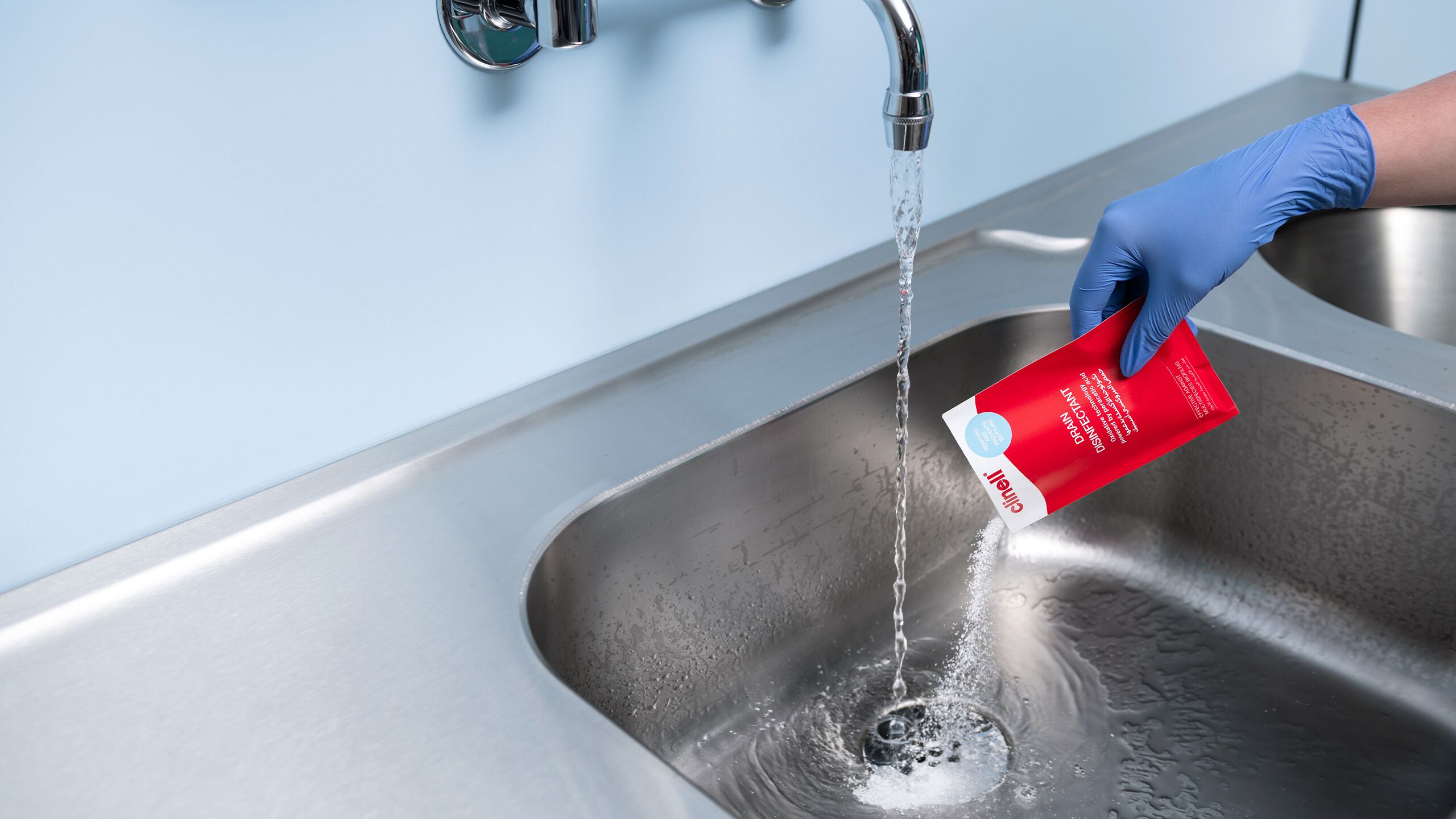 Drain Disinfectant being poured into sink