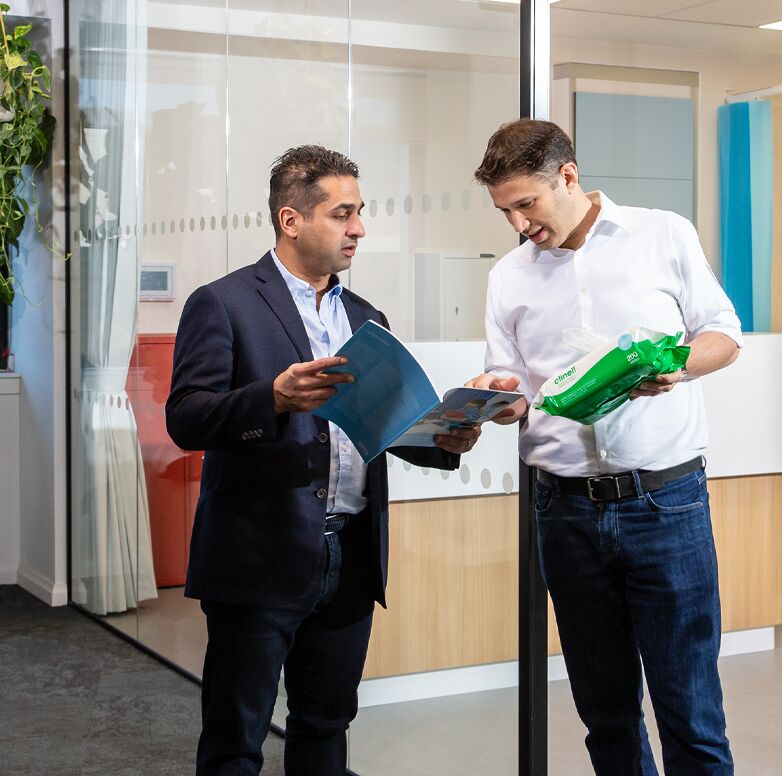 Guy & Allen looking at product brochure